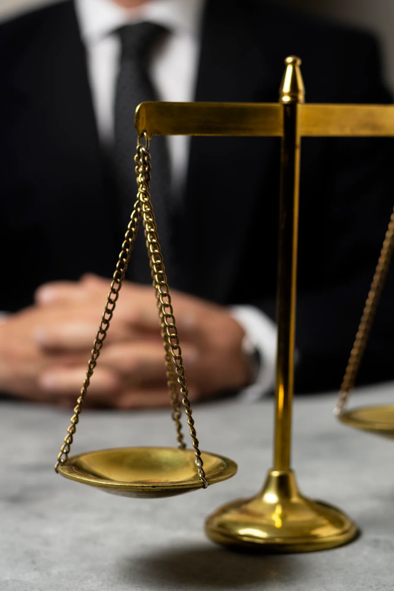Visa requirement policies: scales of justice in the foreground, with a man in a suit in the background representing authority in the definition of visa requirements.